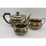 ATKIN BROTHERS A GEORGIAN DESIGN THREE PIECE SILVER TEASET, oval fluted form comprising teapot,