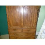 A 19TH CENTURY MAHOGANY LINEN PRESS with carved cornice over two plain doors, having part fitted