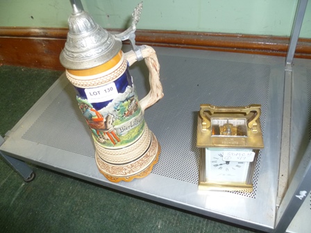 A MUSICAL GERMAN BEER STEIN together with A BRASS CARRIAGE CLOCK bearing the legend J.W. Benson