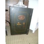 A VINTAGE GREEN FINISHED METAL SAFE bearing the name 'Cartwright & Sons, West Bromwich' (keys in