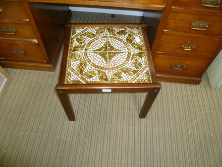 A SMALL TILE TOP TABLE