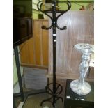 A BLACK FINISHED FREE-STANDING HAT, COAT AND STICK STAND
