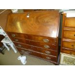 A GEORGIAN MAHOGANY BUREAU having full width fall down writing slope revealing a well fitted