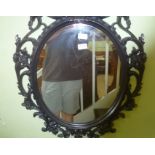 A BLACK FANCY FRAMED OVAL PLAIN PLATE WALL MIRROR