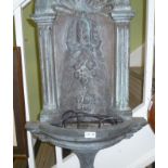 A VERDIGRIS PATTERNATED CAST WALL MOUNTABLE WATER FEATURE
