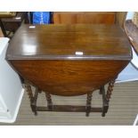 A SMALL SIZED OAK TWIN FLAP GATELEG TABLE on barley twist and blocked legs