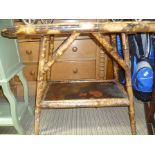 A LATE 19TH CENTURY BAMBOO FRAMED RECTANGULAR TWO TIER TABLE with lacquered insert panels in