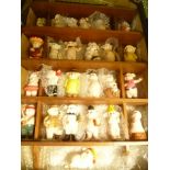 A BOX CONTAINING A WOODEN DISPLAY SHELF HOUSING A LARGE SELECTION OF CERAMIC PIG FIGURINES