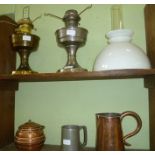 TWO 20TH CENTURY OIL LAMPS one with chimney and milk glass shade, together with a pewter pint