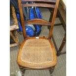 A PROBABLE LATE 19TH CENTURY WOODEN ROCKING CHAIR with bergere seat