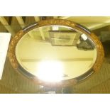 A SMALL FANCY FRAMED OVAL BEVEL PLATE WALL MIRROR