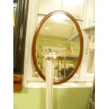 A STRUNG MAHOGANY OVAL FRAMED BEVEL PLATE WALL MIRROR