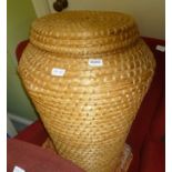 A WOVEN LIDDED ALIBABA BASKET