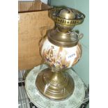 A CERAMIC WELL, BRASS BASED OIL LAMP with globular shade and chimney