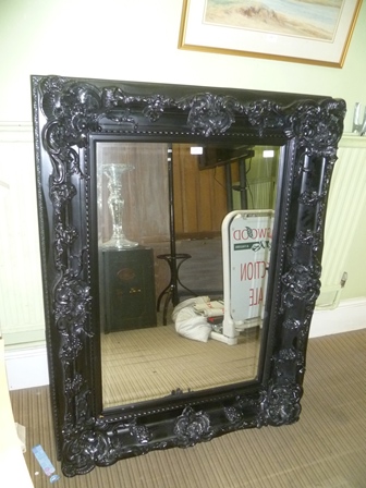 A LARGE RECTANGULAR BEVEL PLATE WALL MIRROR in fancy moulded black finished frame