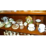 A SHELF FULL OF COLLECTABLE POTTERY AND PORCELAIN to include pot lids, cups and saucers etc.