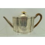 BENJAMIN MONTAGUE A GEORGE III SILVER TEAPOT, serpentine form with chased floral swag decoration,