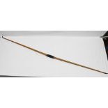 A VICTORIAN MIXED TIMBER LONG BOW, carved horn tips, tooled leather grip, stamped "Buchanan