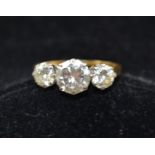 A THREE STONE DIAMOND RING, central stone brilliant cut approx. 1.4 carats, flanked by two