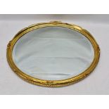 A GILT FRAMED OVAL BEVELLED PLATE WALL MIRROR