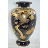 A JAPANESE SATSUMA POTTERY VASE of baluster form, cobalt blue ground, gilded with exotic birds in