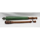 A VICTORIAN EQUINE PILL PUSHER, turned yew wood, iron banded. together with a European turned wood