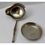 AN 18TH CENTURY WHITE METAL TODDY LADLE having lipped bowl inset with a coin, together with a coin