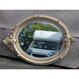 A LATE 20TH CENTURY ANTIQUE DESIGN OVAL BEVELLED PLATE WALL MIRROR with moulded craquelure