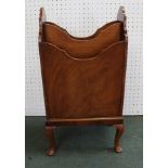 A MAHOGANY MAGAZINE RACK on cabriole supports, 68cm high