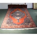 A PERSIAN DESIGN RUG, burnt orange ground, central stylised floral centre, deeply bordered and