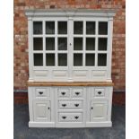 A GEORGIAN DESIGN IVORY PAINTED PINE DRESSER with dentil cornice, over two glazed doors on
