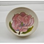 A MOORCROFT SHALLOW BOWL with tube lined flower head, having impressed marks to underside