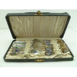 TWENTY-ONE SILVER COLOURED METAL COLLECTOR'S SPOONS with enamelled emblems and decoration, each