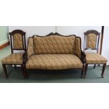 AN EDWARDIAN CARVED MAHOGANY SHOW WOOD FRAMED SALON SOFA together with a pair of single chairs,