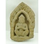 A 12TH CENTURY CARVED LIMESTONE "PRAYING HERMIT" IN NICHE from Angkor Wat, 33cm x 20cm (Provenance -