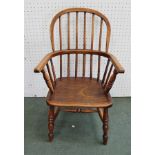 A CHILD'S PROVINCIAL WINDSOR STICK BACK ARMCHAIR, having elm seat, on ring turned supports united