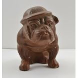 "HITLER'S TERROR" A SECOND WORLD WAR POTTERY BULLDOG, wearing helmet, 15cm high