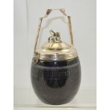 GUEST BROTHERS A 19TH CENTURY BLACK GLAZED POTTERY BASED BISCUIT BARREL with ornate silver plated