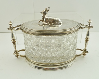 A LATE VICTORIAN BISCUIT CANISTER having silver plated mounts on an oval cut glass body