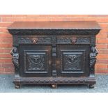 A LATE 19TH CENTURY RENAISSANCE DESIGN CONTINENTAL OAK CABINET, fitted two drawers with mask cup