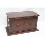AN OAK STORAGE BOX with beaded edge and applied carvings