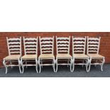 A SET OF SIX PAINTED LADDER BACK SINGLE CHAIRS with woven rush seats by "Sitting Firm"