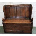 A 20TH CENTURY OAK HALL BENCH SETTLE of Jacobean design, with hinged seat box base, 91cm wide