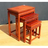 A NEST OF THREE ORIENTAL HARDWOOD OCCASIONAL TABLES, largest 44cm x 30cm