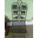 A DECORATIVE FOLDING IRON WORK CHAIR with animal silhouette back and lattice work seat