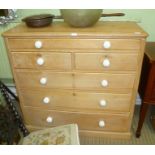 AN EARLYN 20TH CENTURY PINE CHEST OF DRAWERS with later white ceramic knob handles