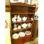 A MAHOGANY SET OF OPEN FRONTED SHELVES the base section having two plain panelled cupboard doors