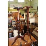 TWO VARIOUS MAHOGANY FINISHED SAUCER TOPPED TORCHERE STANDS