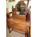A CARVED OAK SINGLE BED HEAD AND FOOT BOARD with metal side rails, together with A DRESSING TABLE