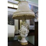 A CONTINENTAL PORCELAIN FLORAL ENCRUSTED TABLE LAMP BASE with tasselled shade